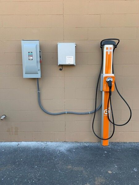 A charging station is attached to the side of a building