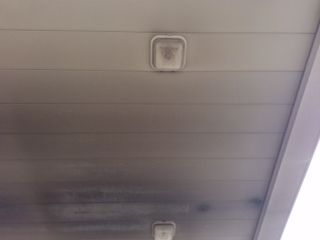 A close up of a ceiling with a light on it.