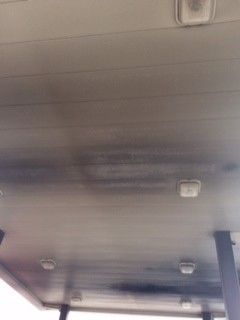 The ceiling of a building with a lot of lights on it.