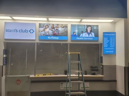A ladder is sitting in front of a sam 's club counter.