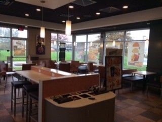 The inside of a mcdonald 's restaurant with tables and chairs