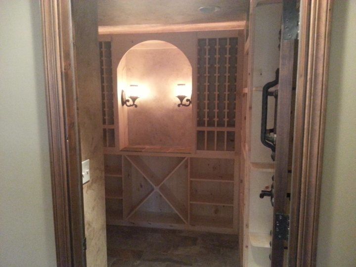 A closet with wooden shelves and a wooden door