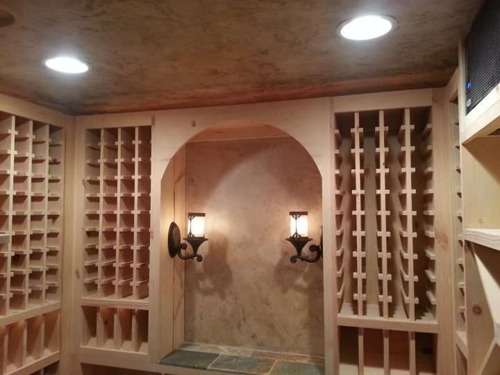 A wine cellar with lots of shelves and lights