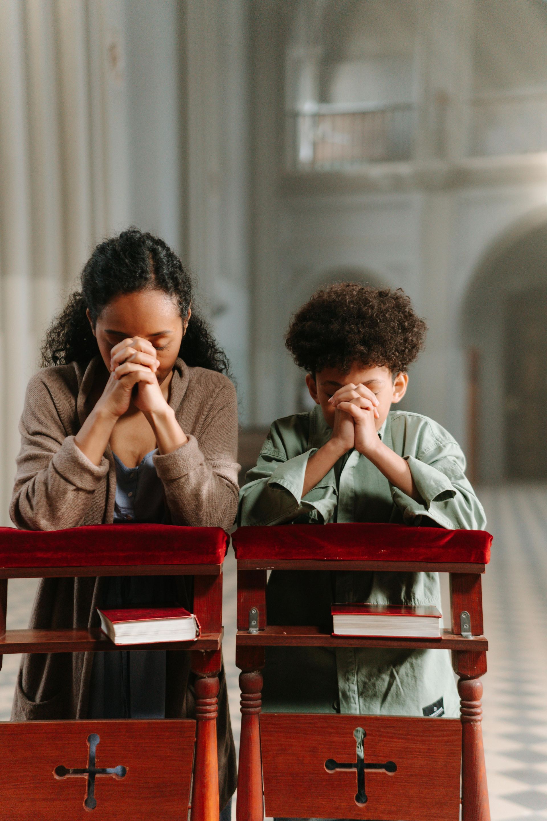 Woman and child praying in church