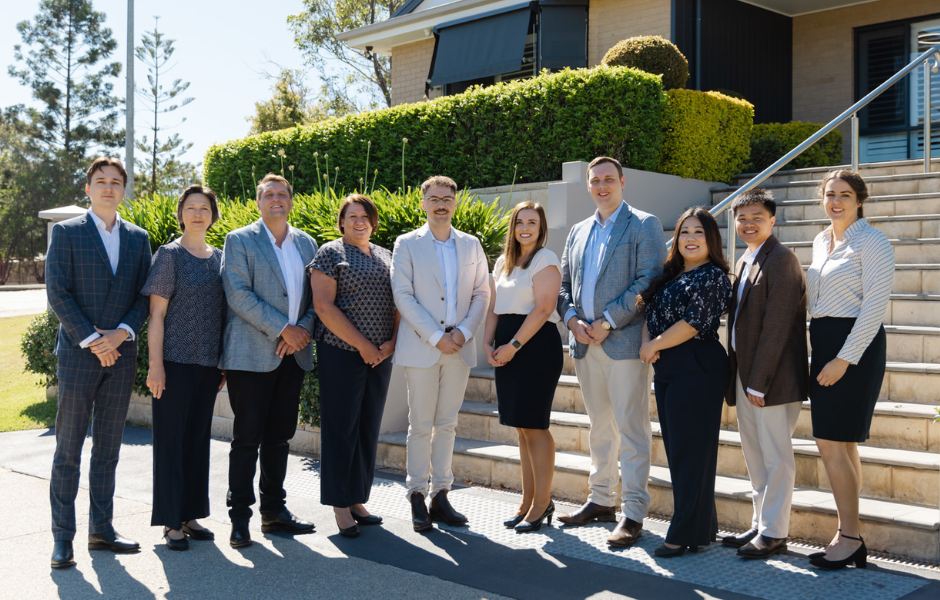 A group of Robards financial planners, associates and administration staff posing for a photo in the Newcastle office.