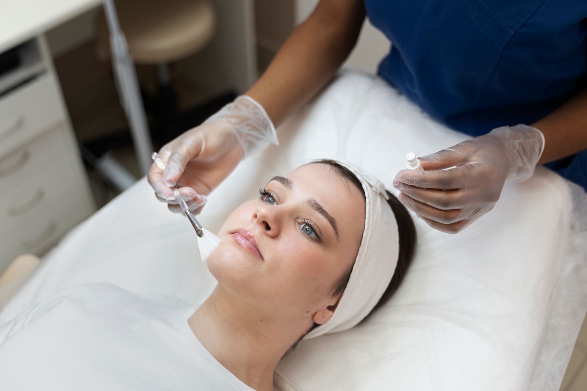 A woman is getting a facial treatment at a beauty salon.