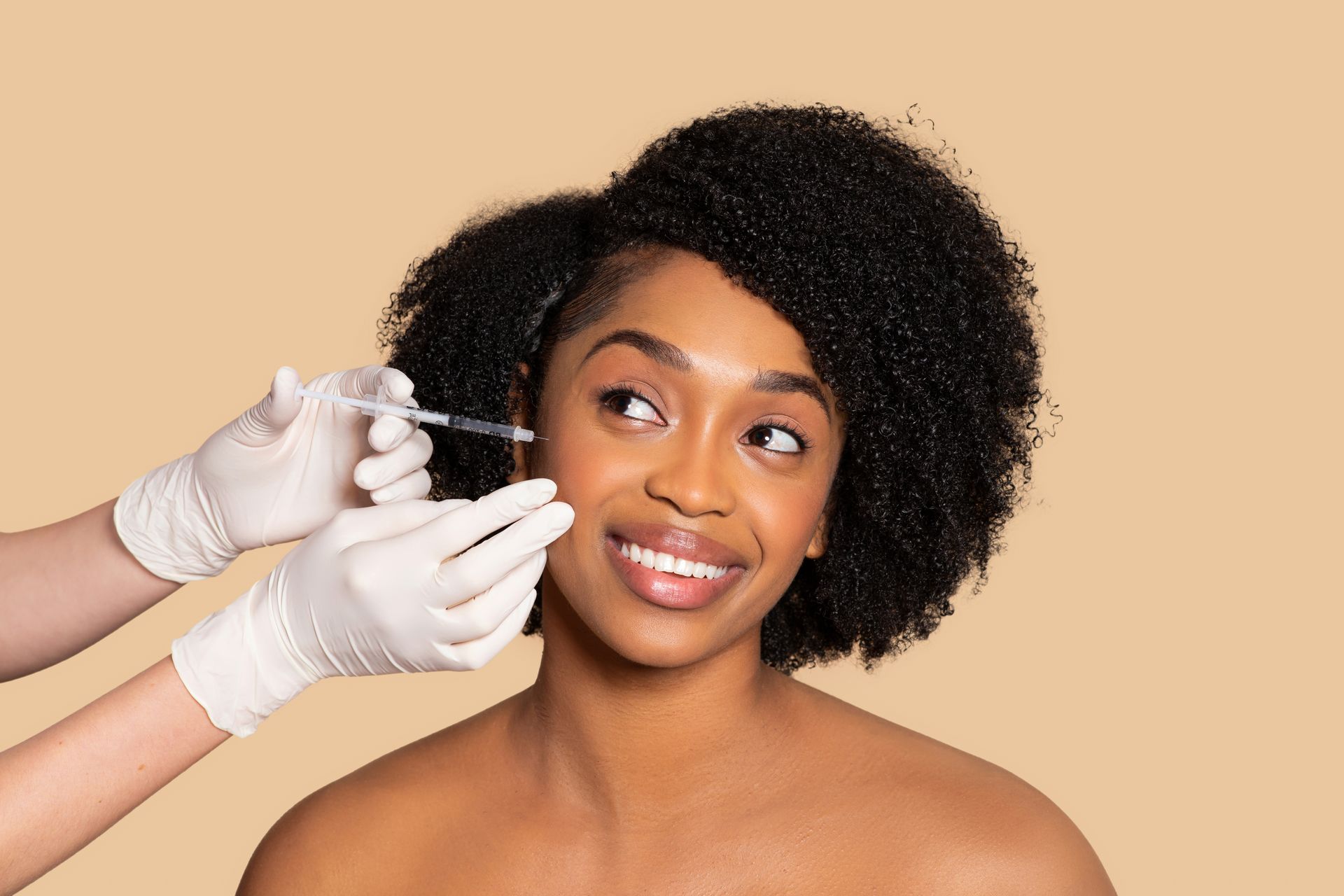 A woman is getting a botox injection in her face.