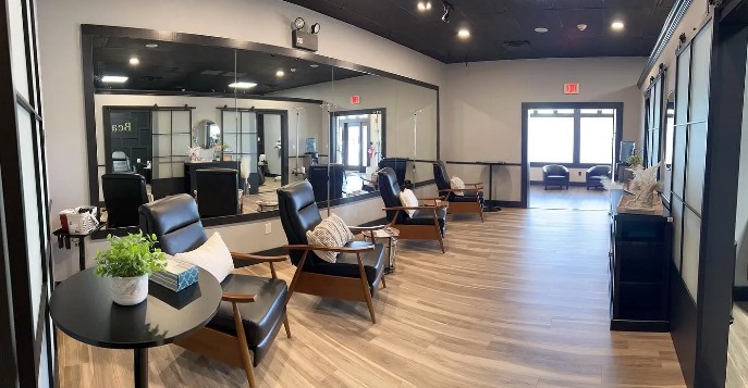 A massage table in a spa room with a large window.