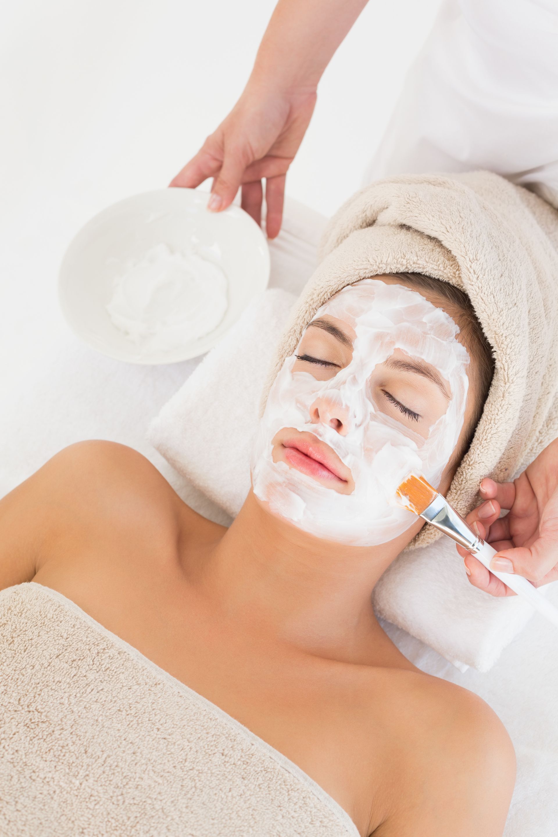 A woman is getting a facial treatment at a spa.