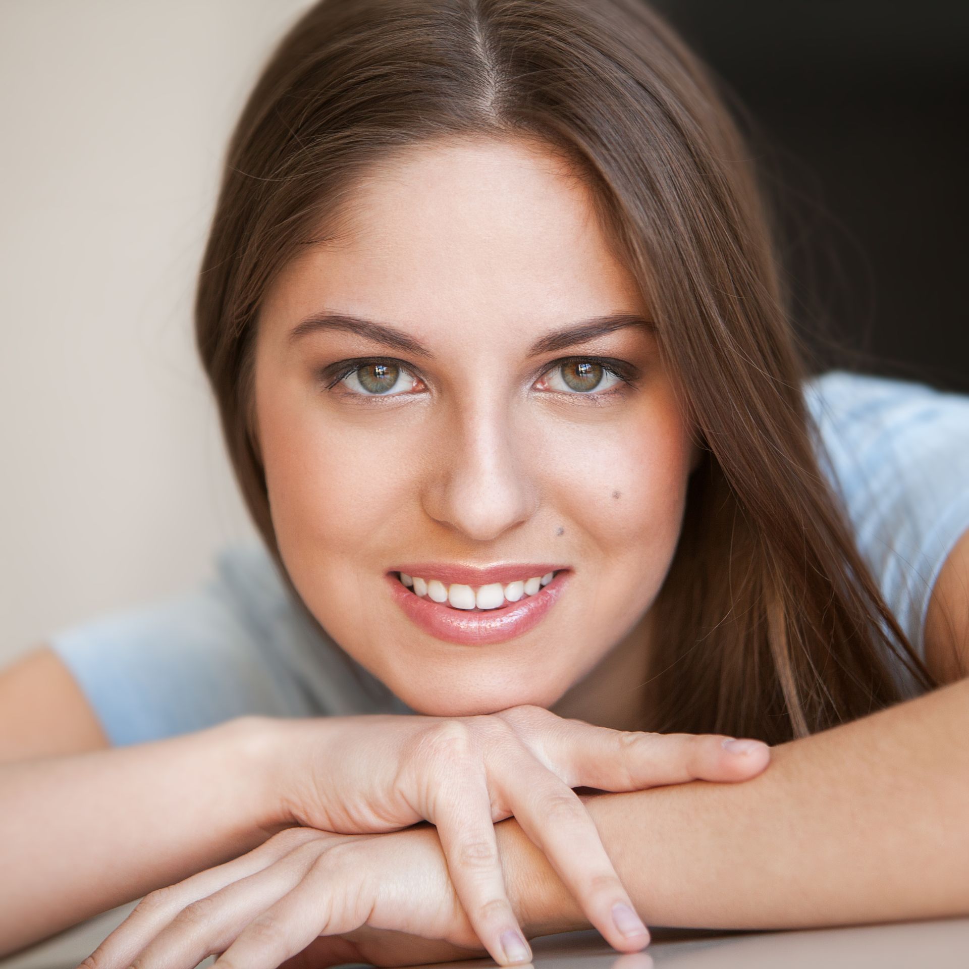 A close up of a woman 's face with a smile on her face.