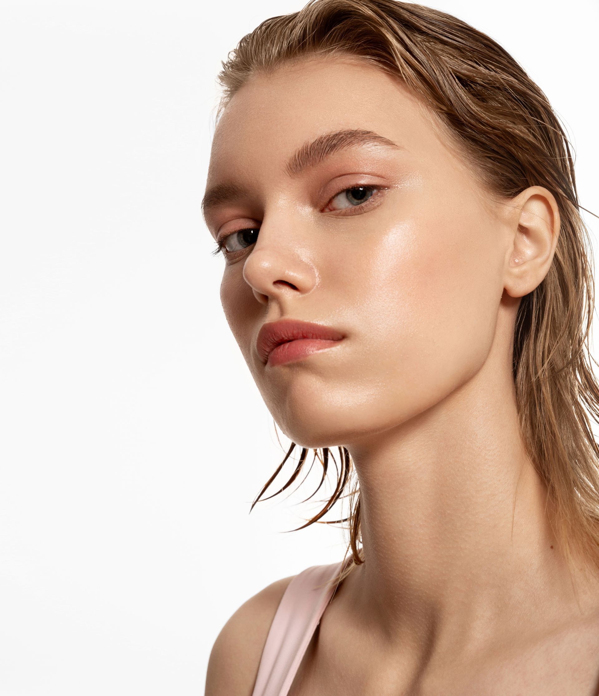 A close up of a woman 's face on a white background.