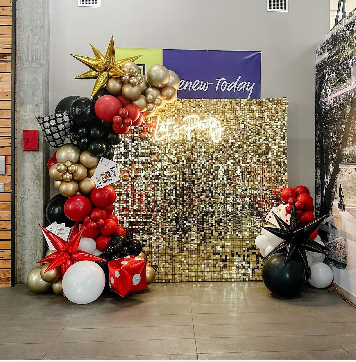 A room with balloons and a sign that says renew today