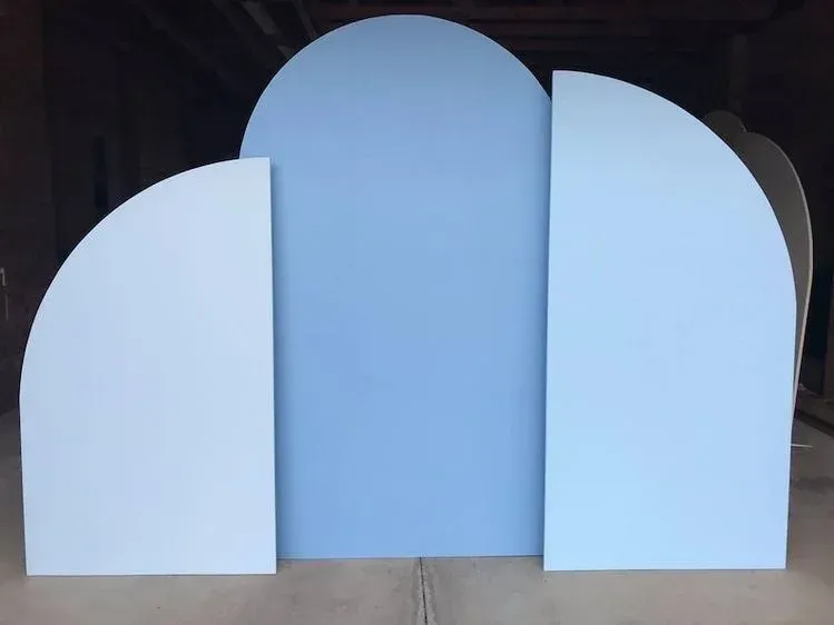 A set of three blue arches sitting on top of a wooden table.