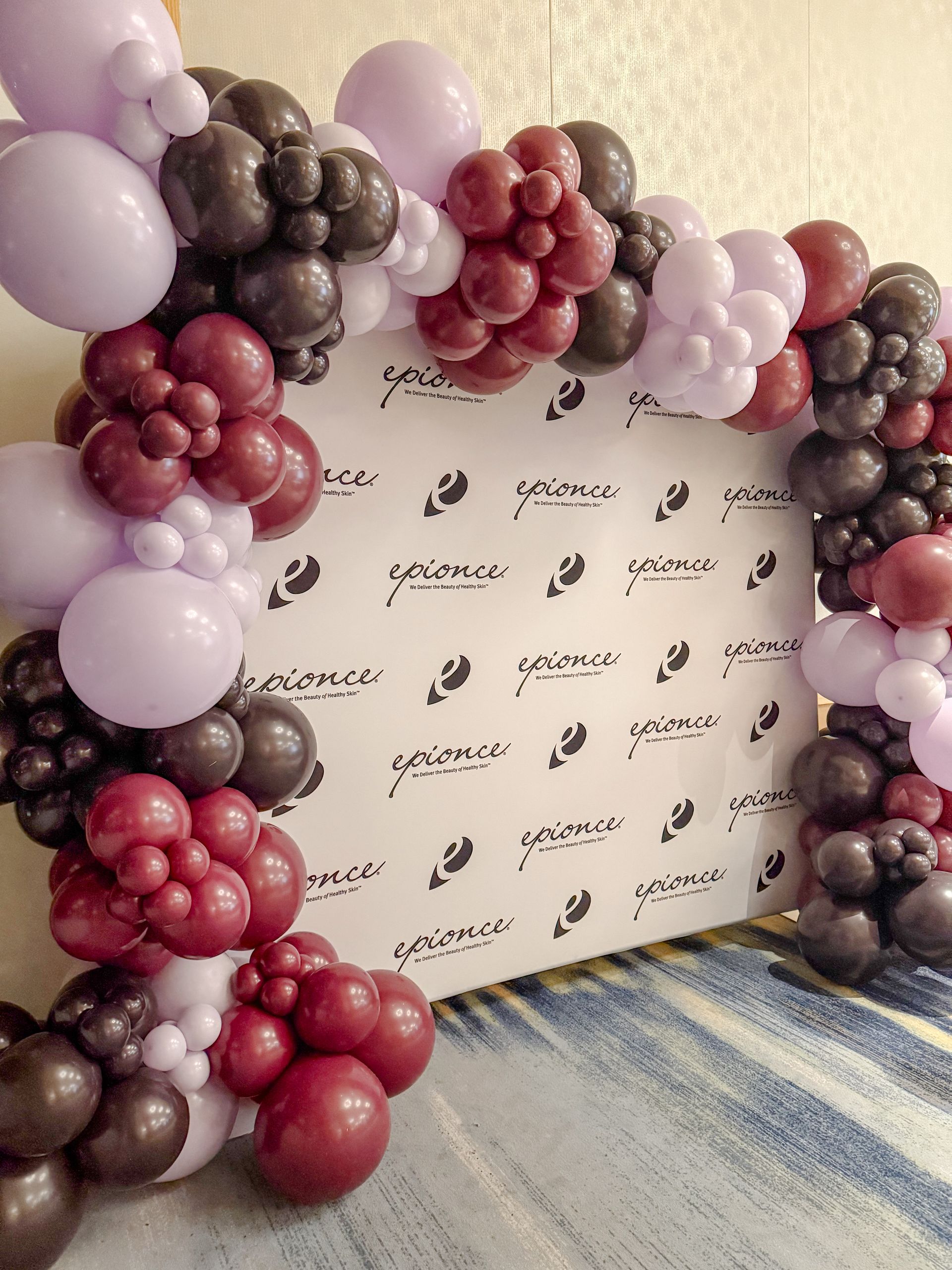 A bunch of balloons are sitting on a wall.