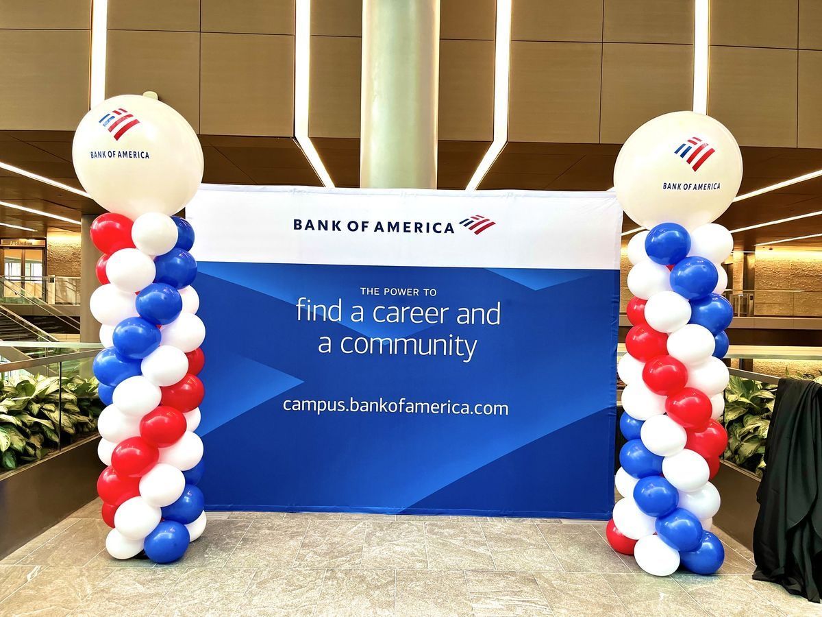 Bank of America display with blue, white, and red balloon columns. Sign: