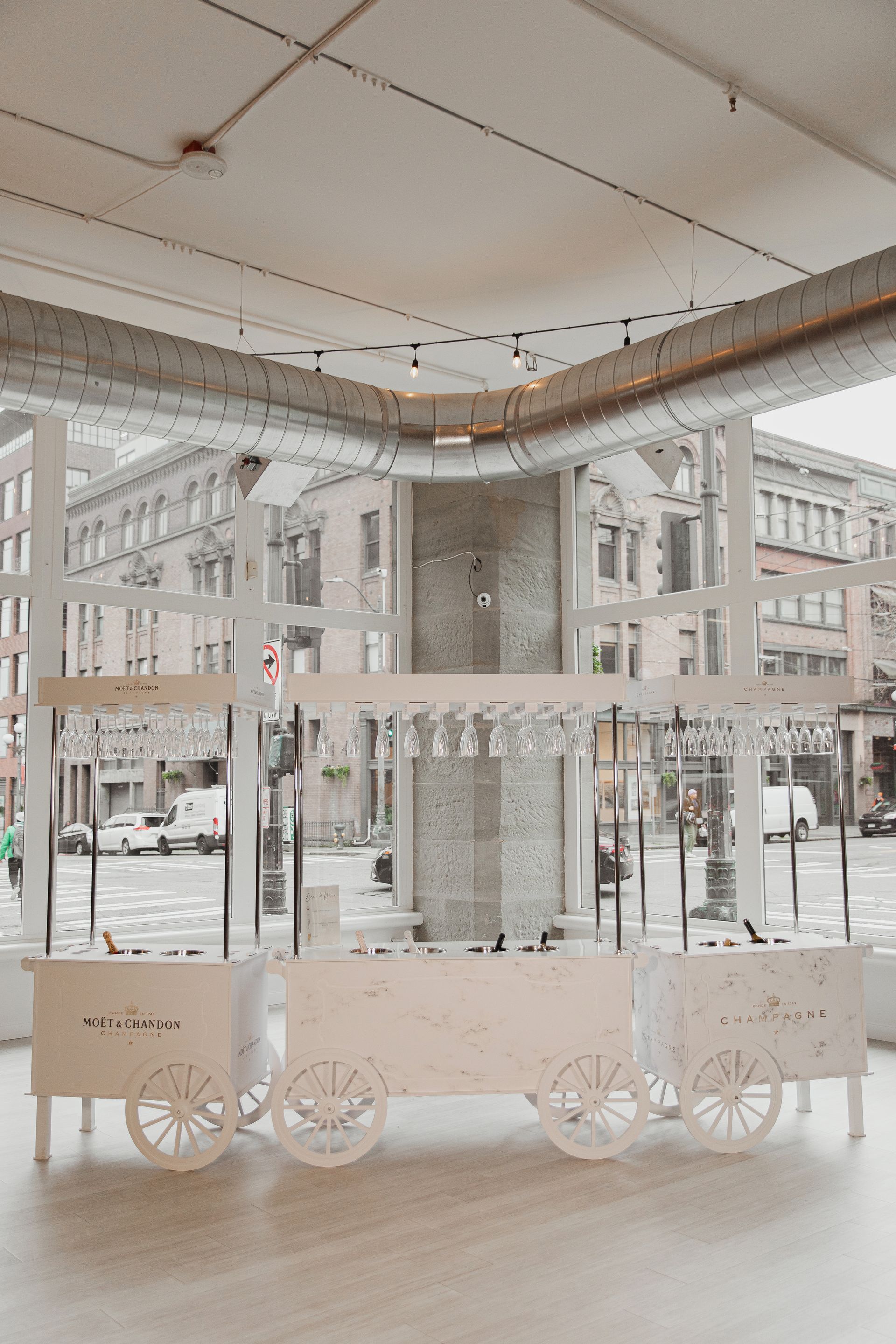 A white cart is sitting on the ground in front of a building.