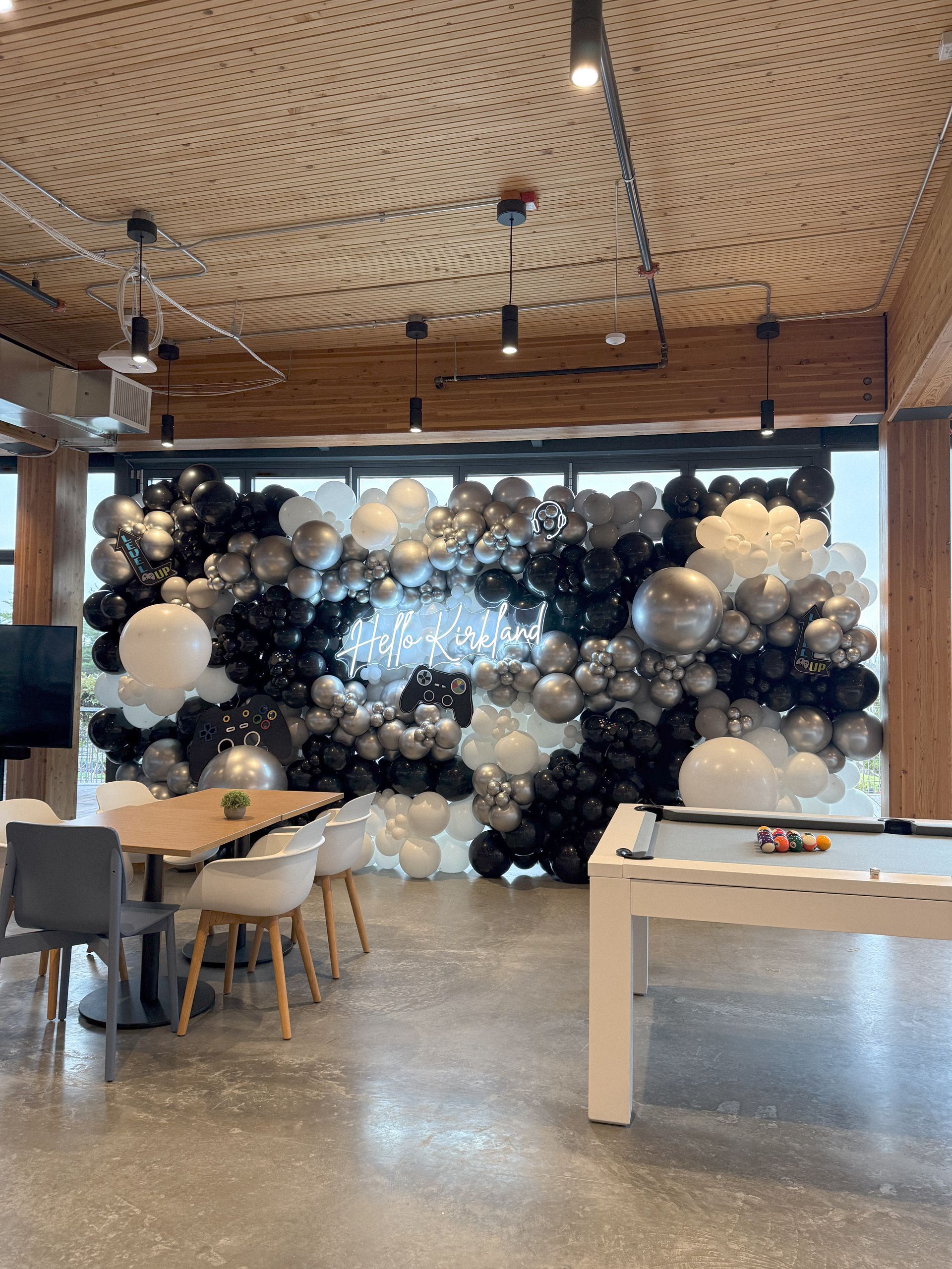 A room filled with balloons and a pool table.