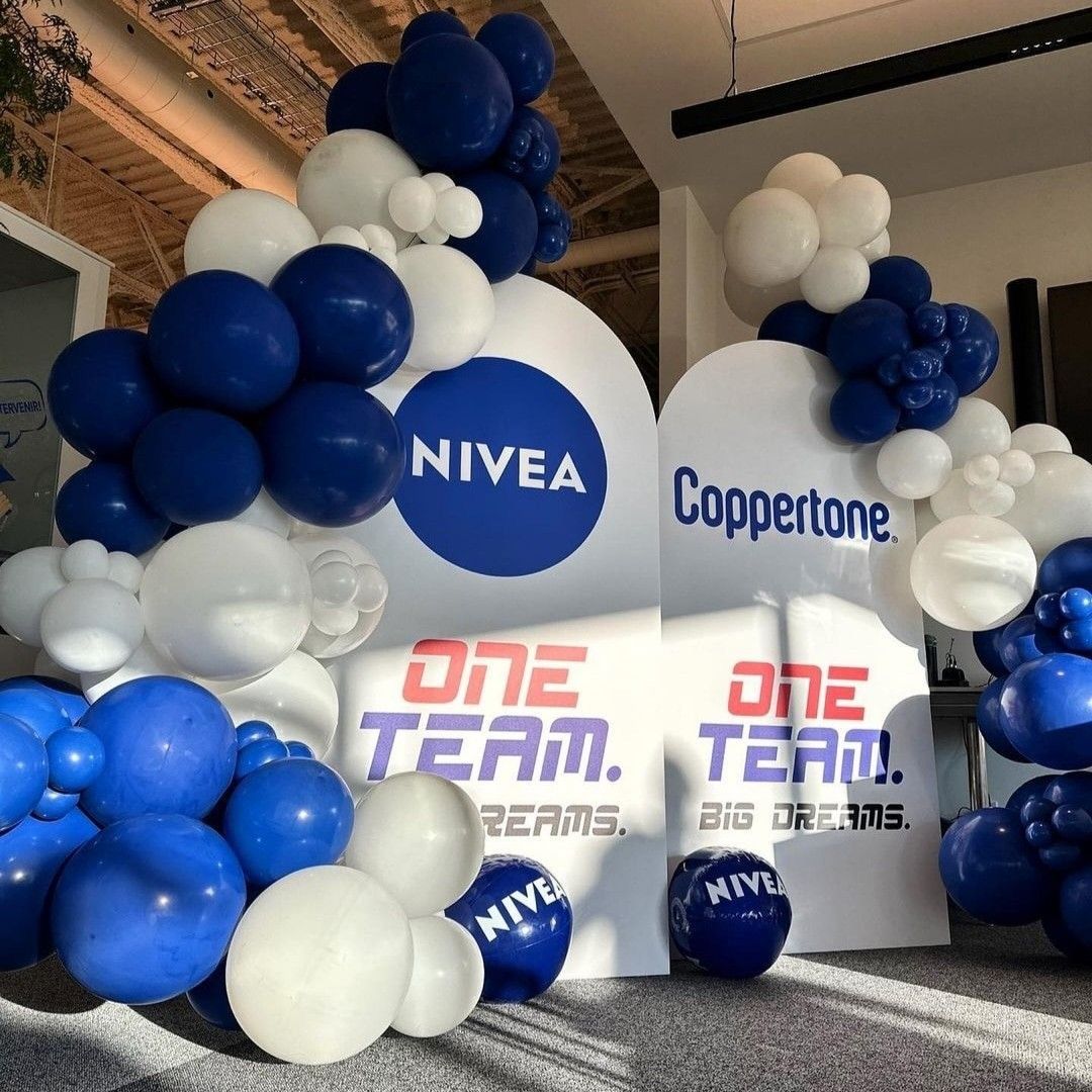 A display for nivea and coppertone with blue and white balloons