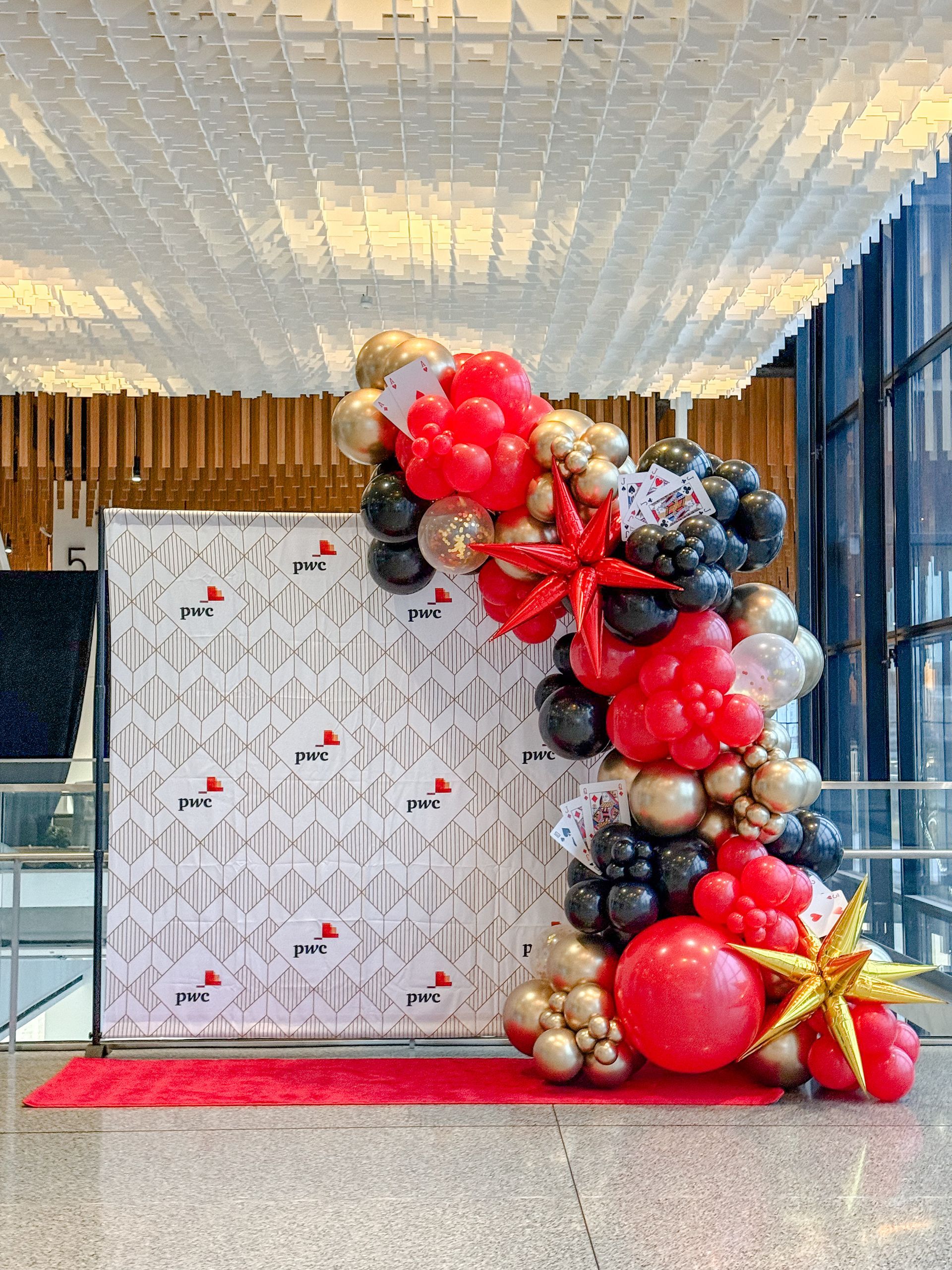 A bunch of balloons are sitting on the floor in front of a wall.