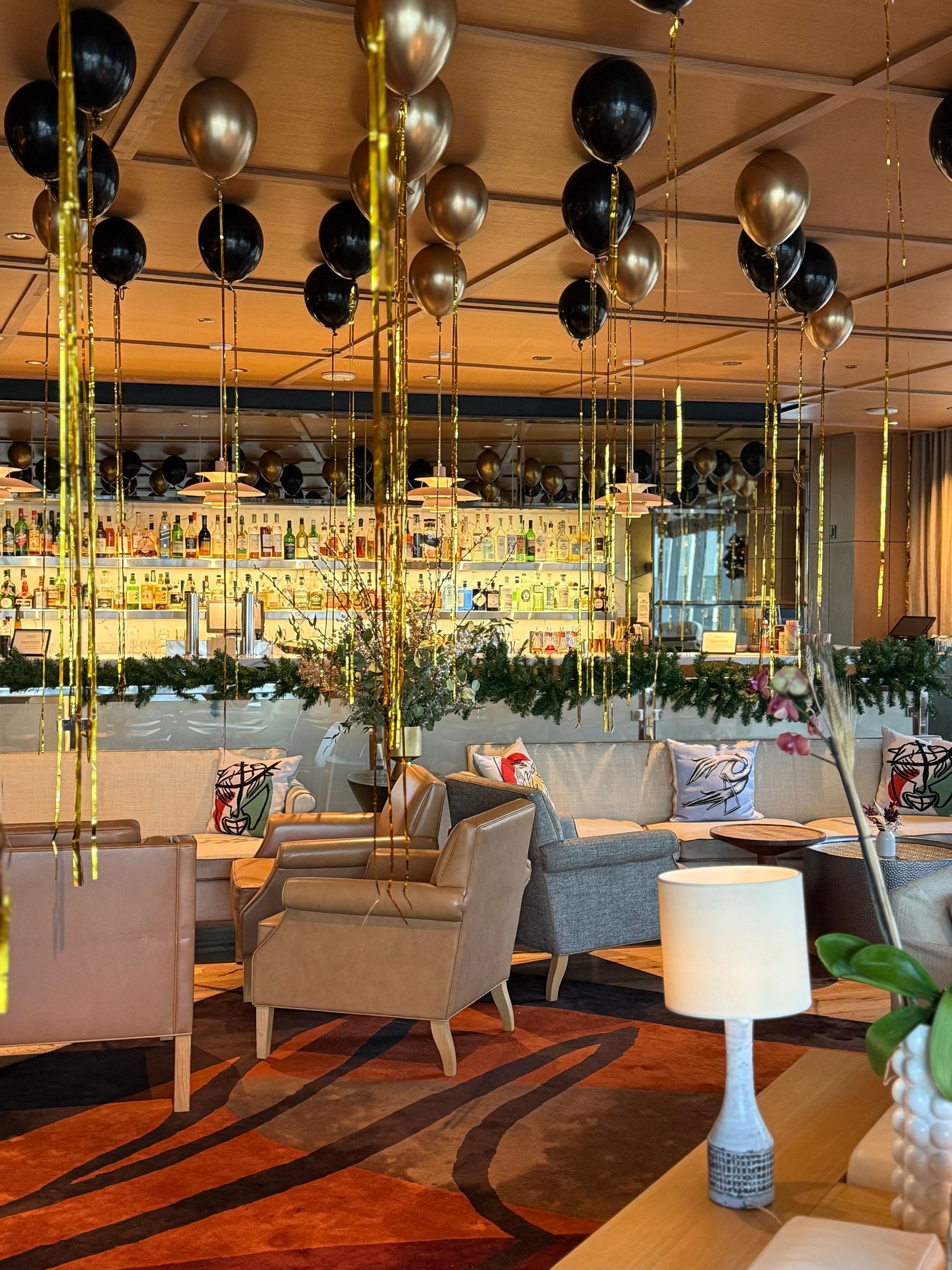 A room with a lot of balloons hanging from the ceiling