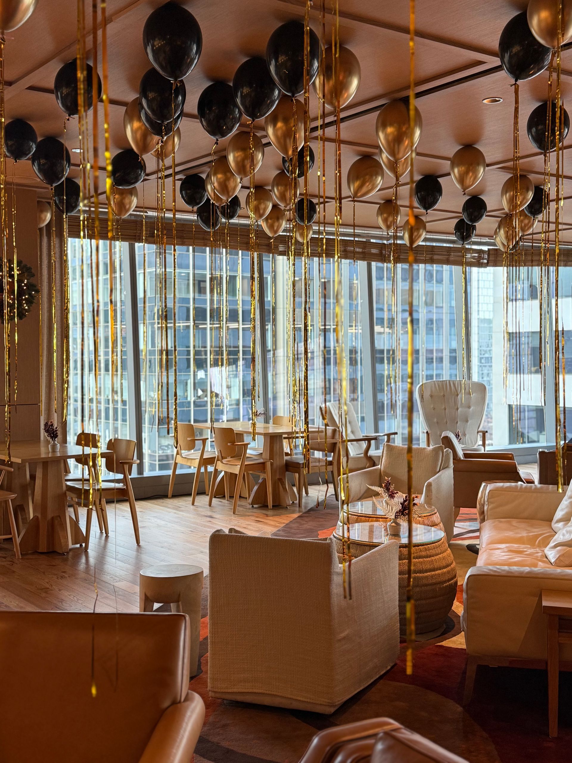 A large room with lots of furniture and balloons hanging from the ceiling