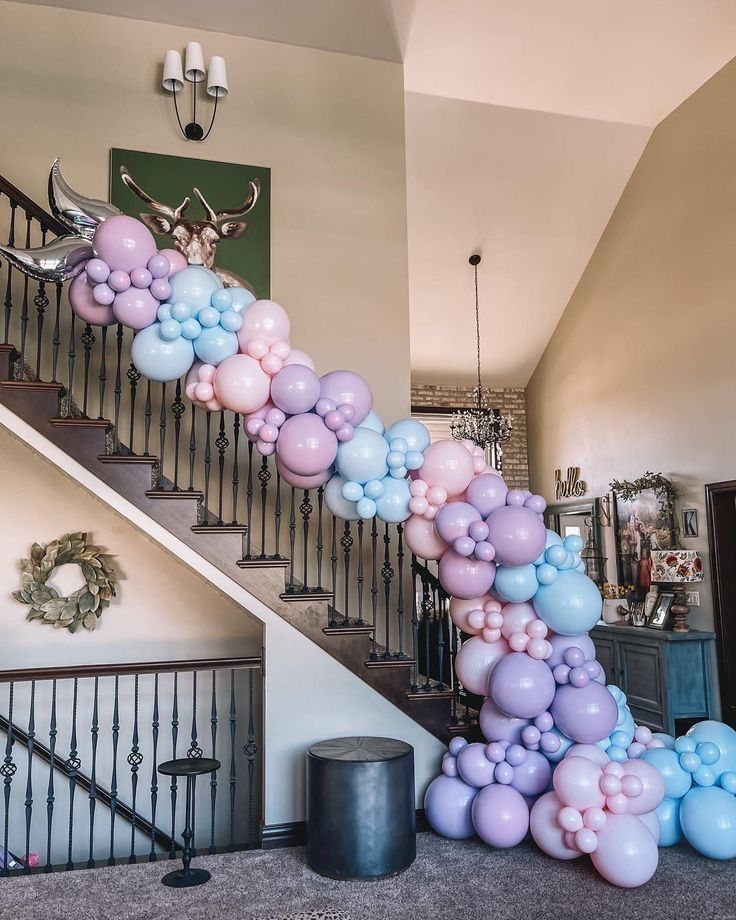 A pastel balloon garland cascading down stairs.