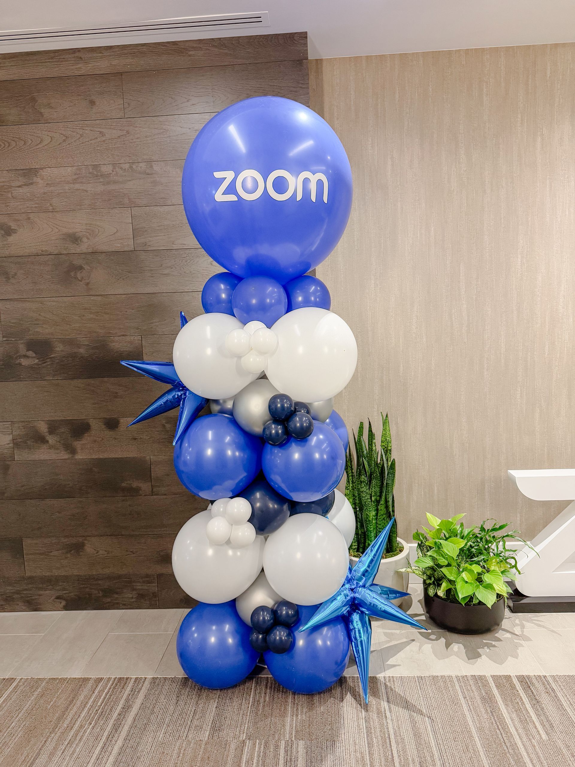 Balloon column for Zoom; blue, white, and star-shaped accents; Zoom logo on top.