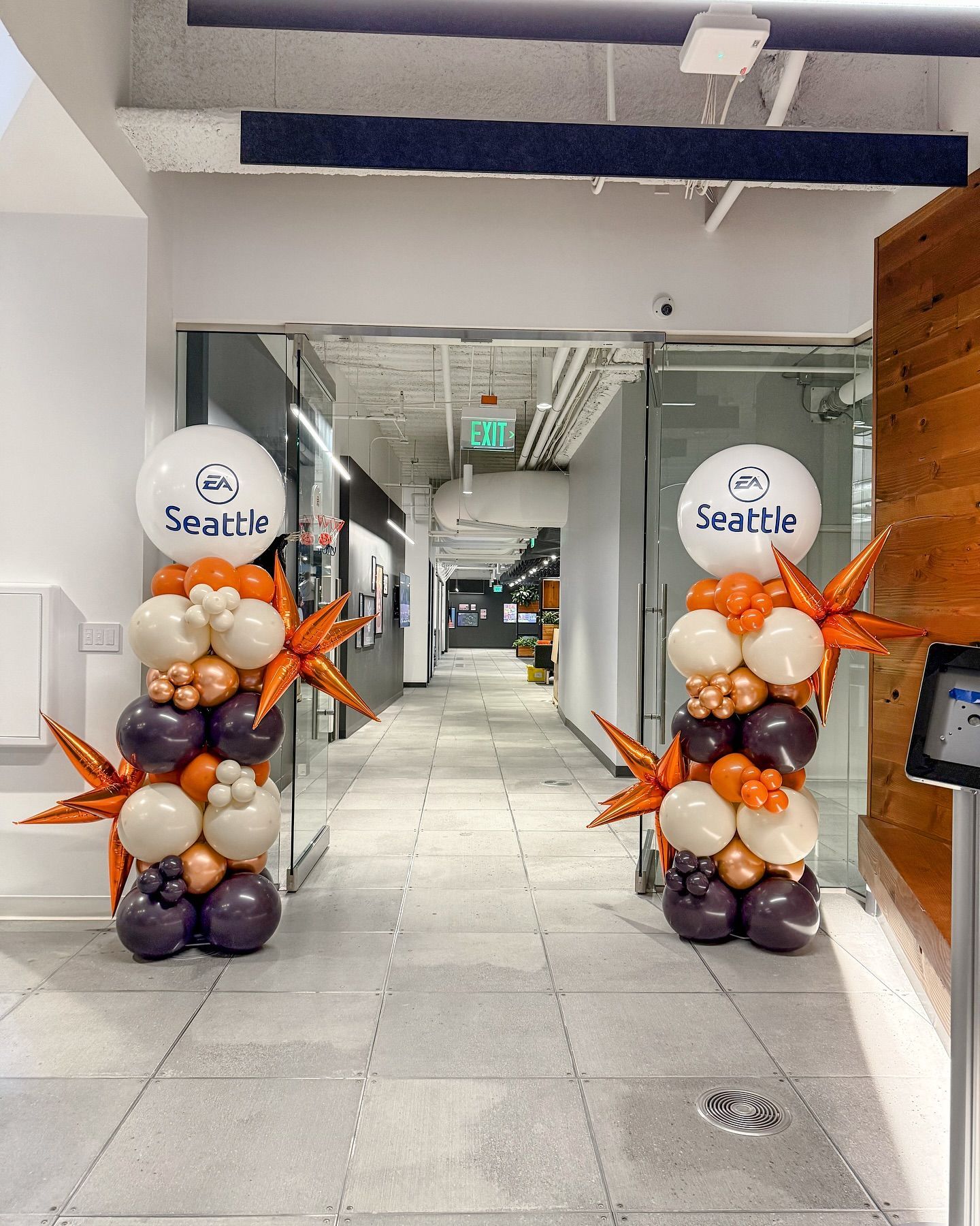A hallway filled with balloons and a sign that says seattle