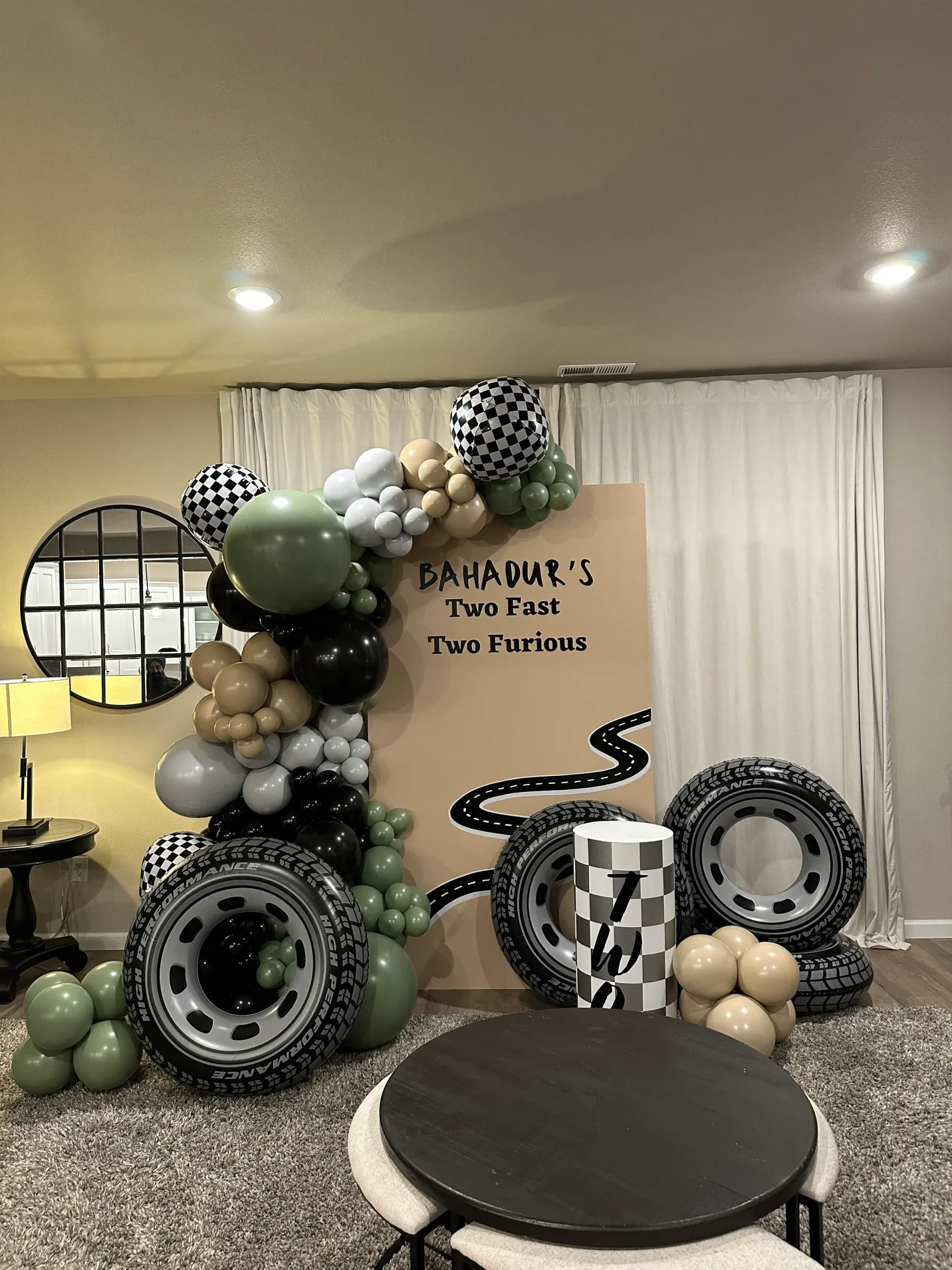 A room filled with balloons and tires and a table.