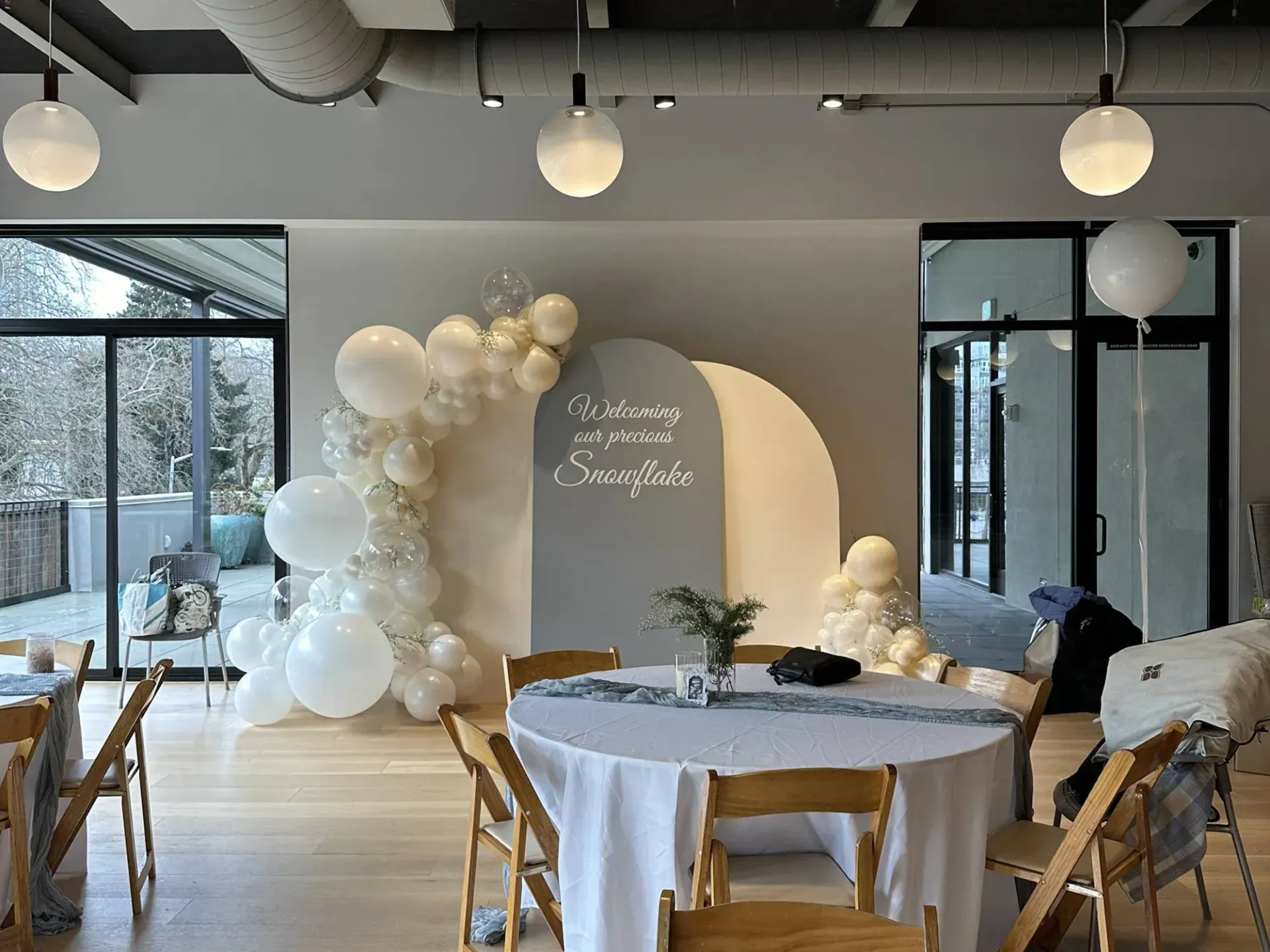 A room with a table and chairs and balloons on the wall.