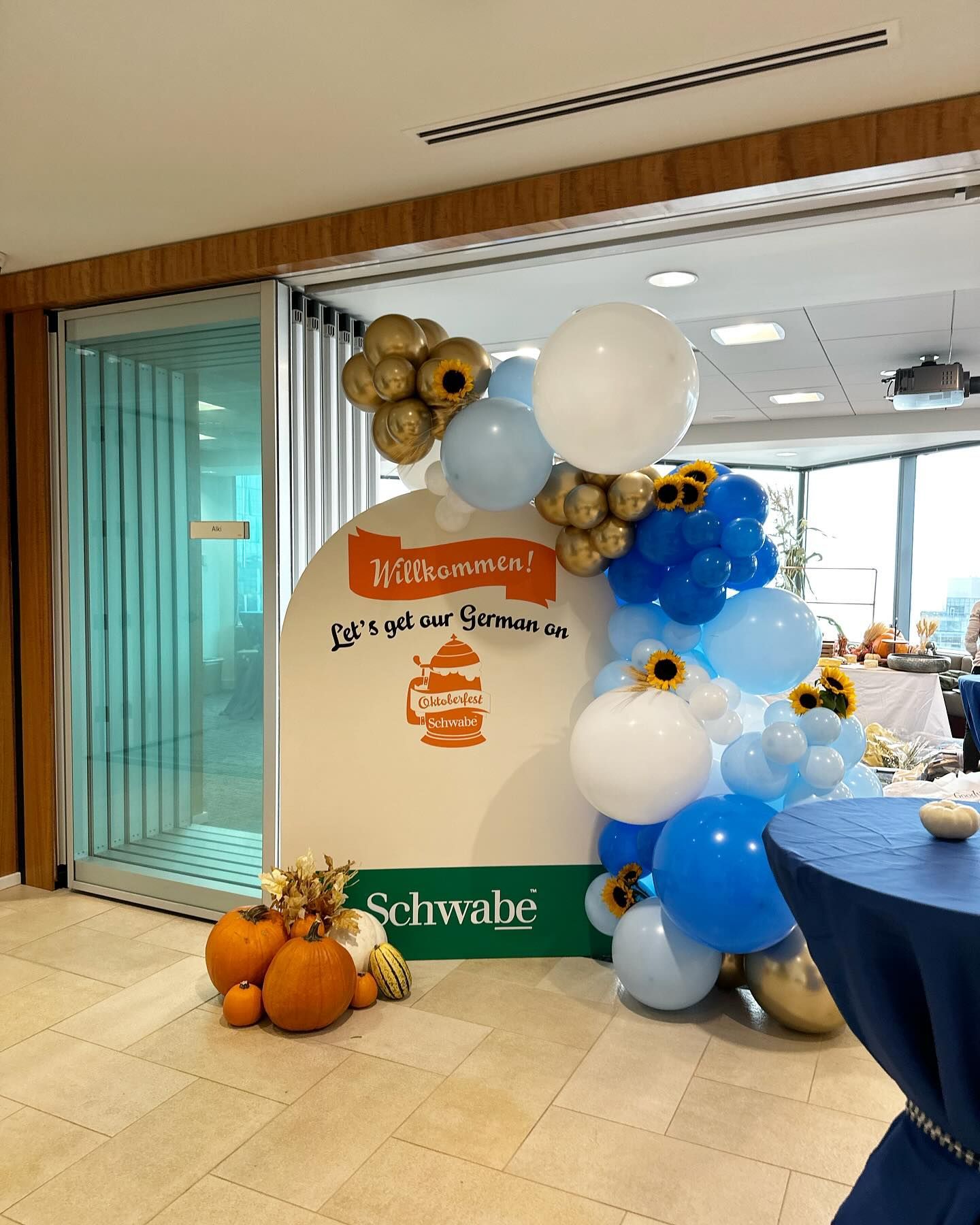 A room with balloons , pumpkins , and a sign that says schwabe.