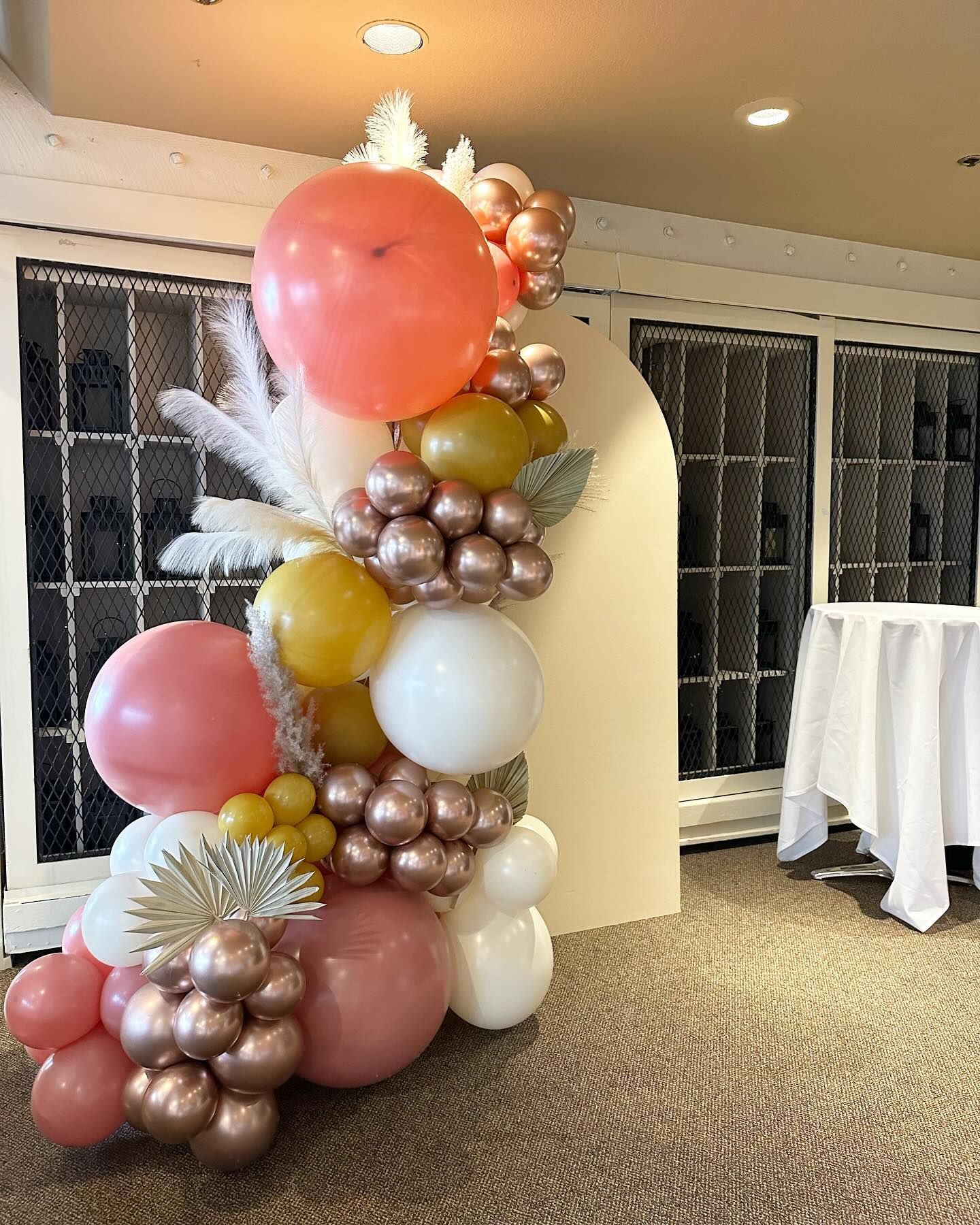 A bunch of balloons are sitting on the floor in a room.