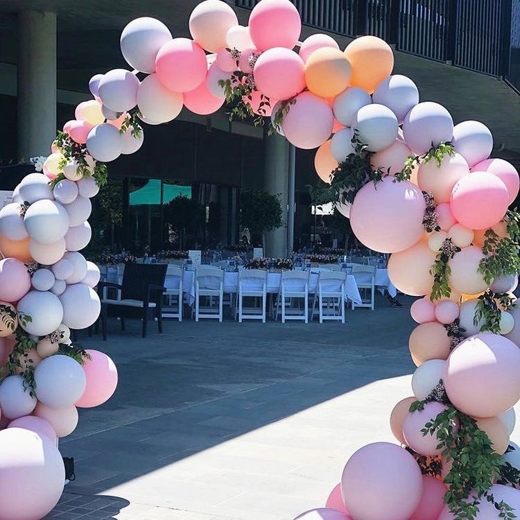 A large arch made of pink and white balloons