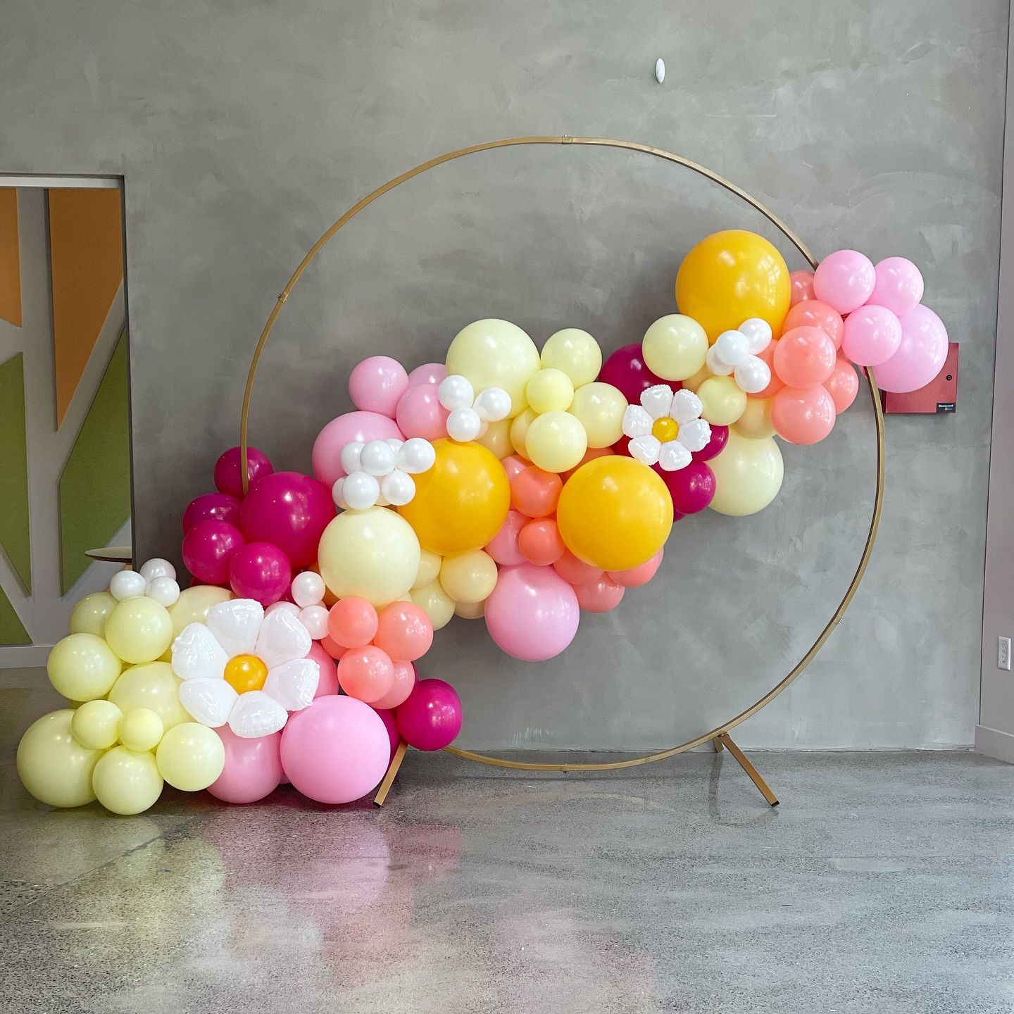 A bunch of balloons and flowers are sitting on the floor