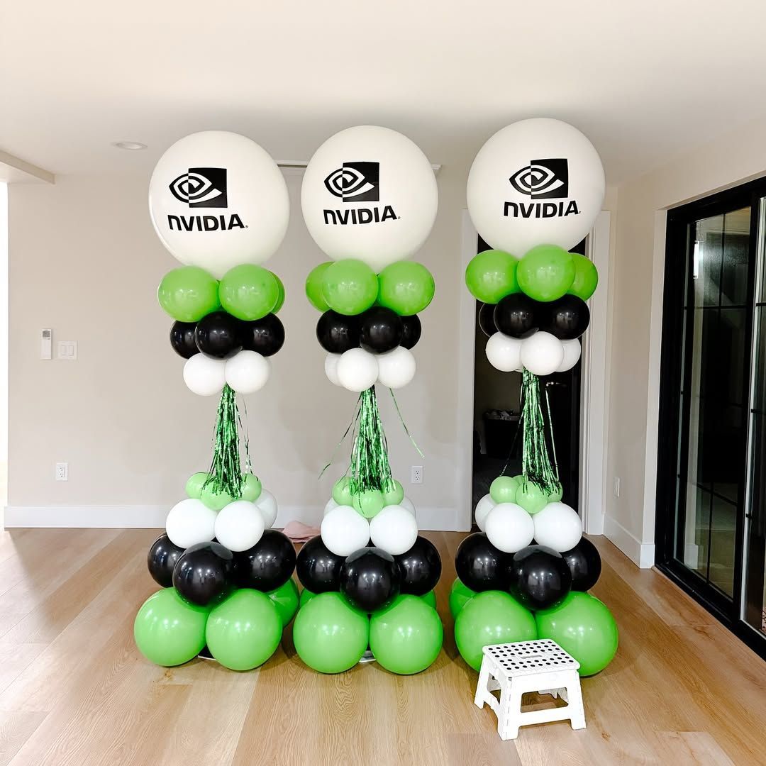 Three NVIDIA logo balloon columns with green, black, and white balloons.
