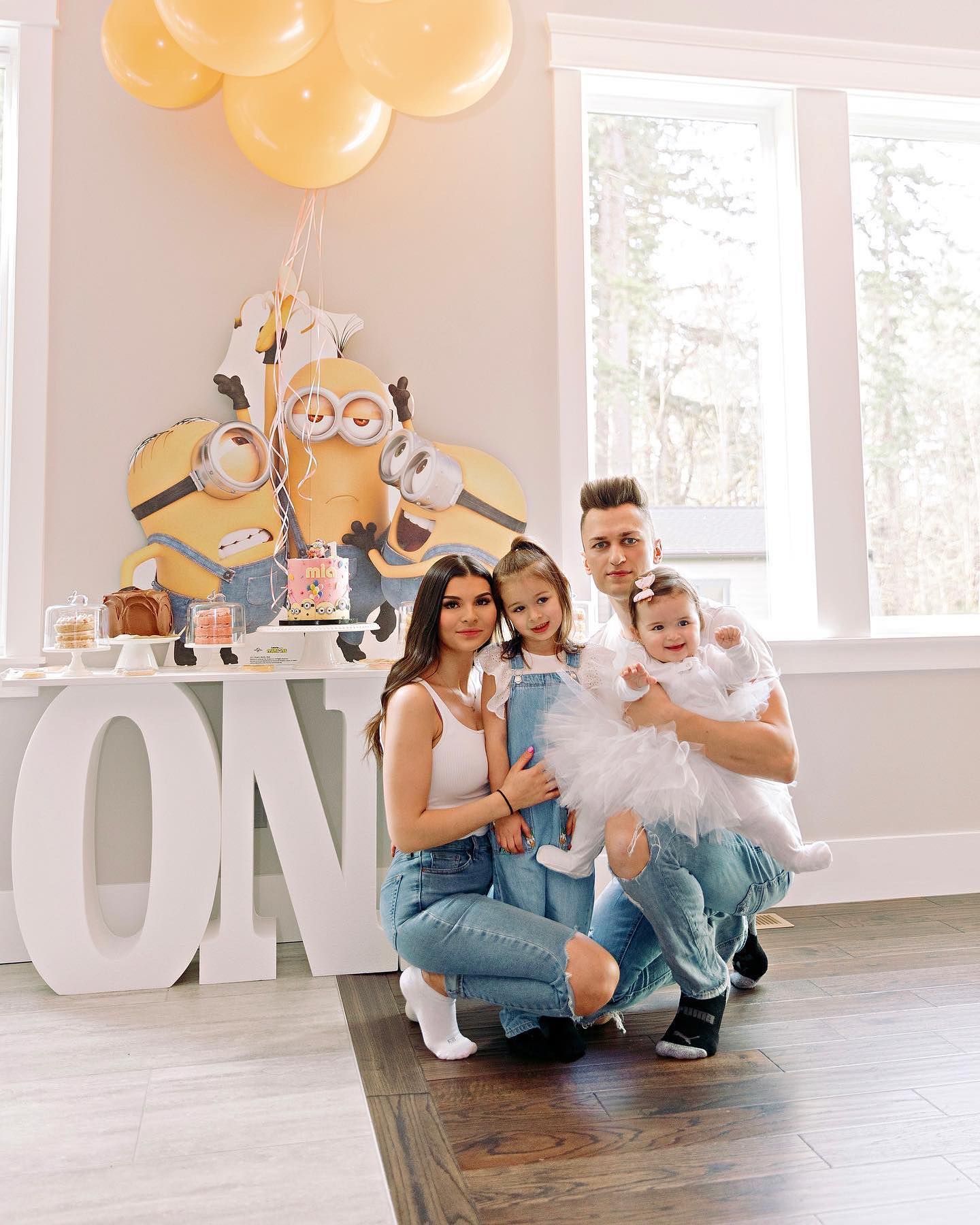 a family is posing for a picture at a minion birthday party
