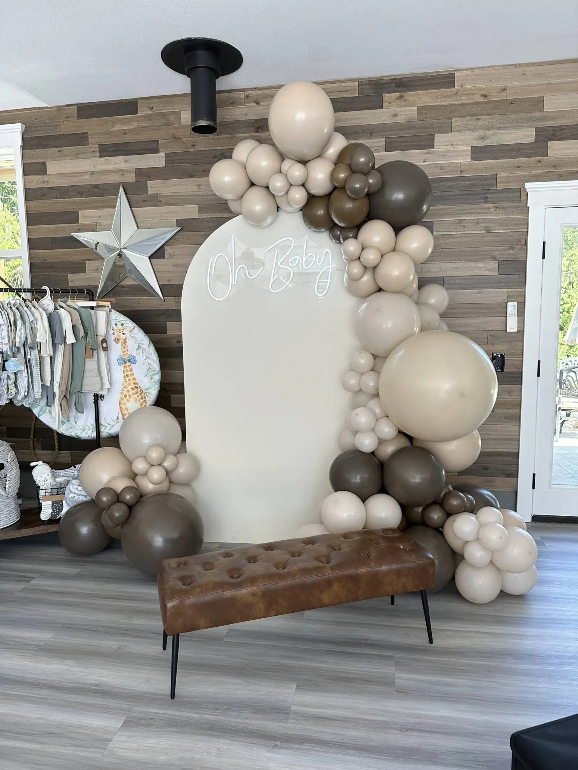 A room filled with balloons and a bench.