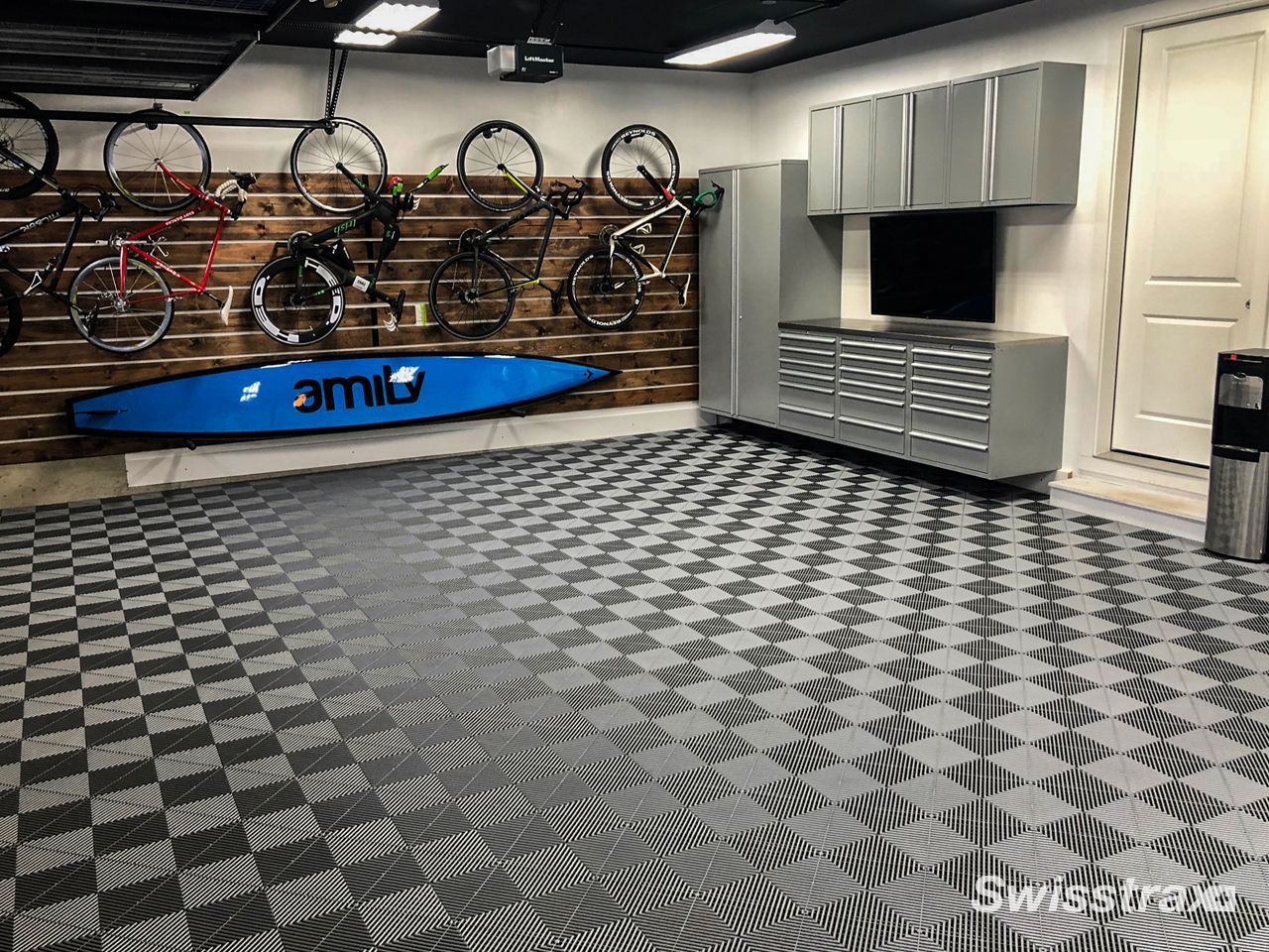Indoor bike shop with rows of bicycles, a blue kayak display, and checkered flooring.
