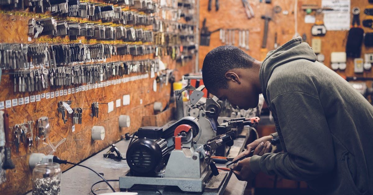 A man is working on a machine in a workshop.