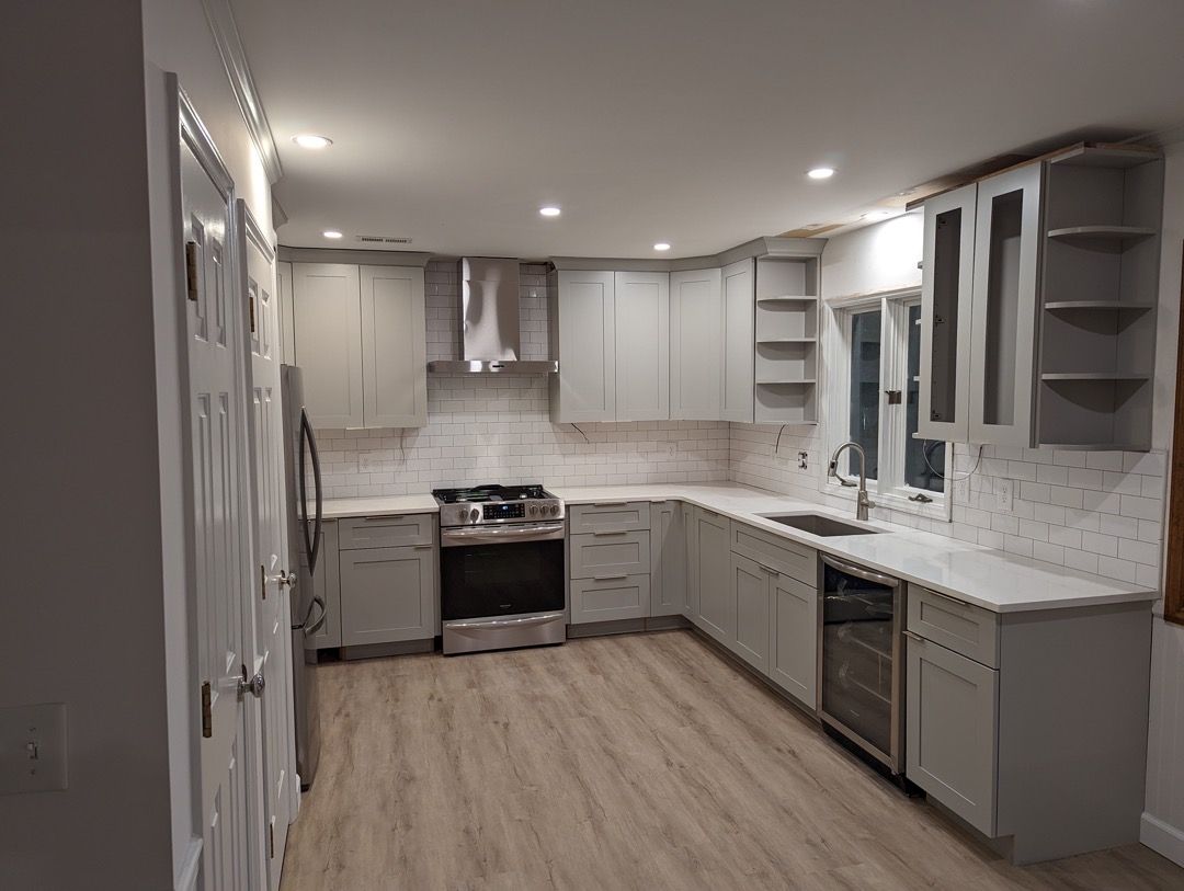 A kitchen with white cabinets and stainless steel appliances.