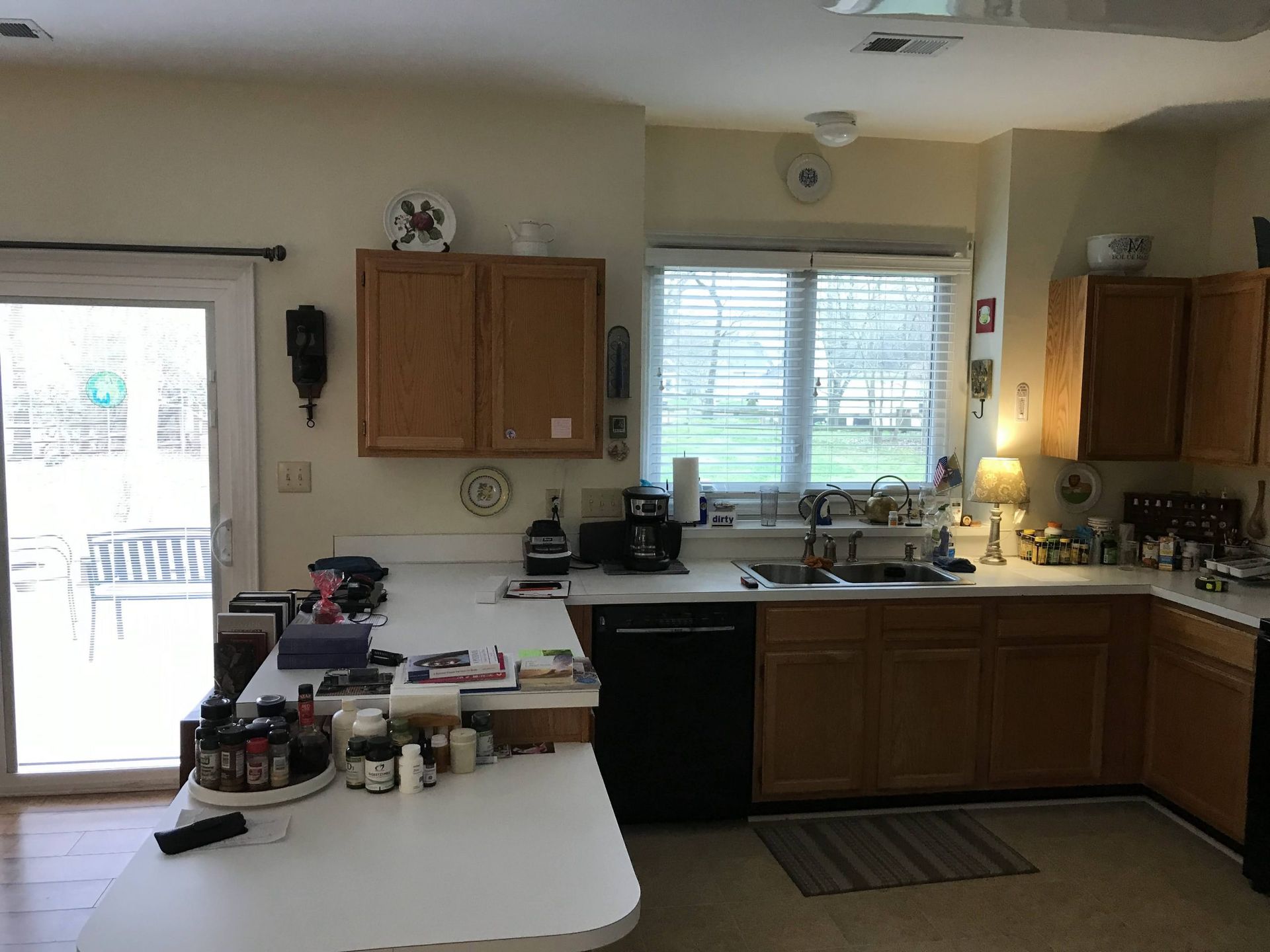 A kitchen with wooden cabinets and a sliding glass door