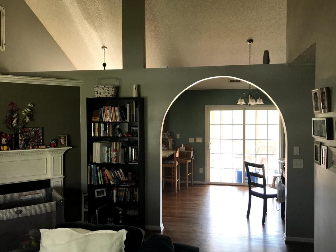 A living room with a bookshelf and a fireplace