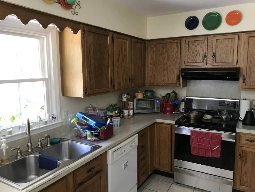 A kitchen with stainless steel appliances and wooden cabinets