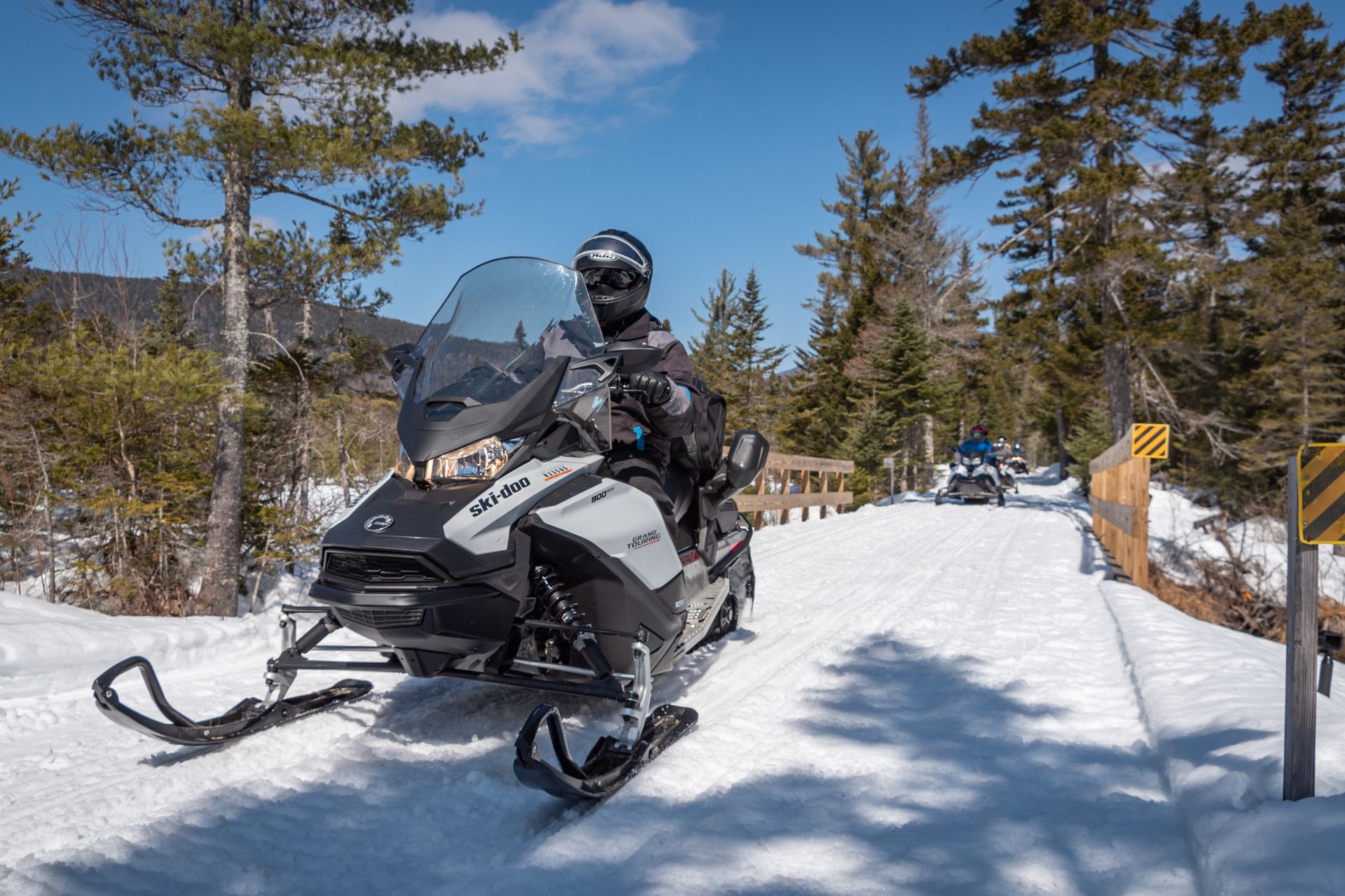 a man riding a ski doo snowmobile on a snowy road