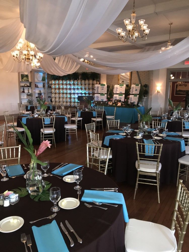 A large room with tables and chairs set up for a party