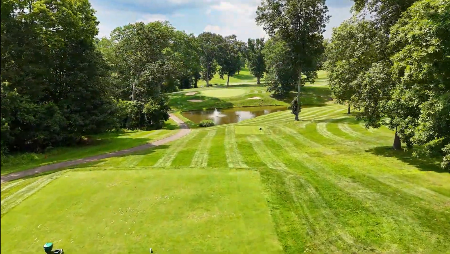 A sprinkler is spraying water on a lush green field.