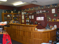 The inside of a store with a wooden counter and shelves