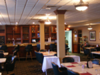 A restaurant with tables and chairs and a bar