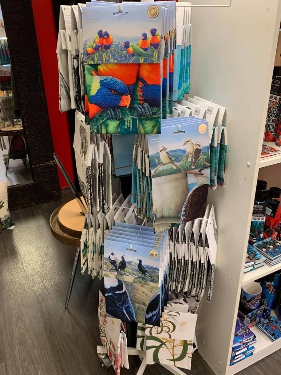 A Display Of Postcards Hanging On A Rack In A Store — InHouse Homewares in Forster, NSW