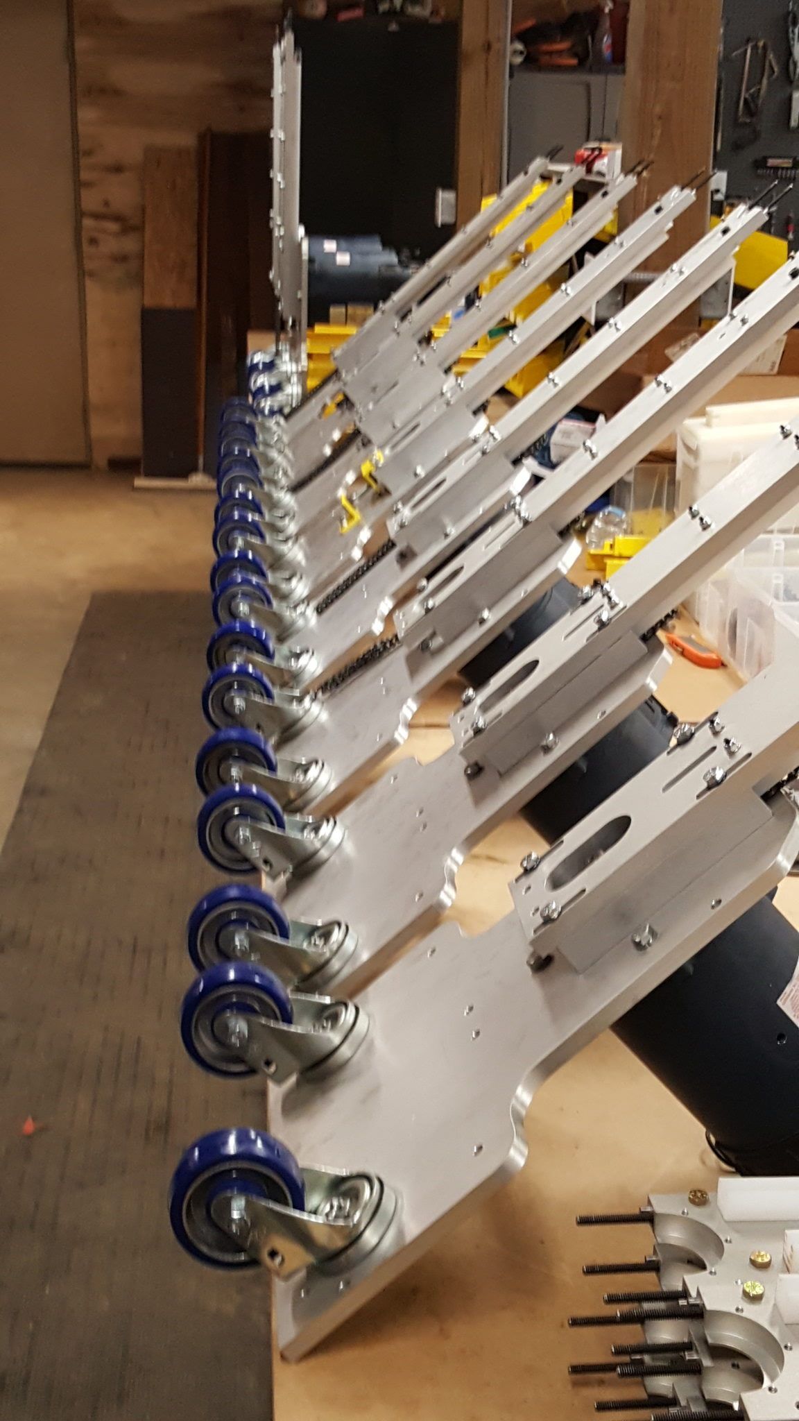 A row of wheels sitting on top of a wooden table.